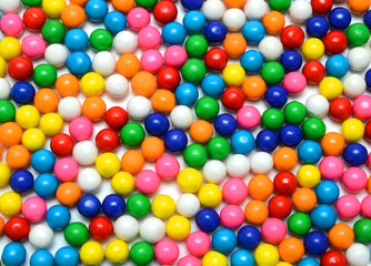 Fototapeta na wymiar Colorful background of assorted shiny round gumballs
