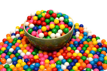 A bowl of colored shiny round gumballs