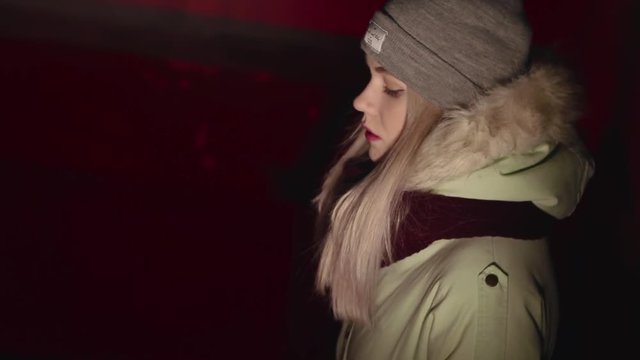 Beautiful young girl breathing at the cold dark place fashion style