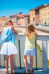Fototapeta na wymiar Little adorable girls taking selfie in Pisa, Italy. Photo about european vacation