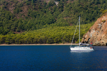 Yatch on calm sea water near coast of Turkey