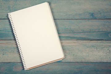 Blank notebook on wooden background