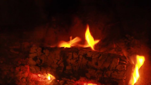 Beech Log burning - slow flames - close-up - blurring out fast