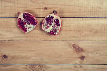 Parts of pomegranate on wooden table
