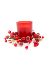Winter, Christmas, New Year decoration. Isolated on white background. Closeup. Front view.Red candle with glass candle holder in ring of red berries. 