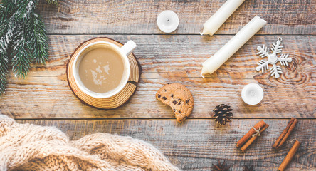 Christmas muffler with cup of cocoa wooden background top view