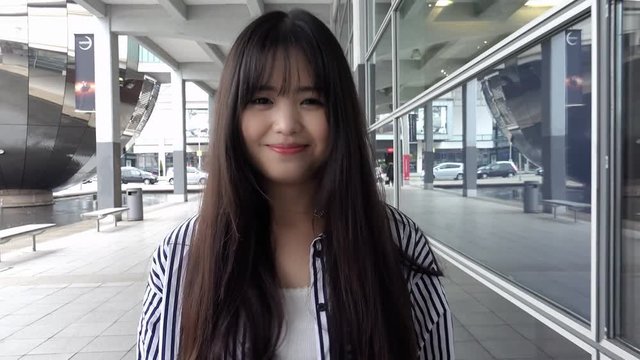 Young Adult Chinese Woman Walking Toward The Camera