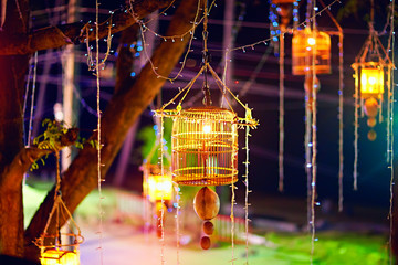 bamboo bird cages, lanterns hanging on the tree. New Year, Thailand