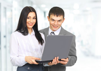 woman receptionist with a laptop and the client on the backgroun