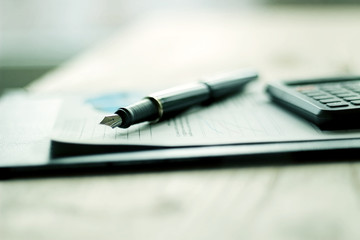 pen, cellphone and business documentation of the modern workplace