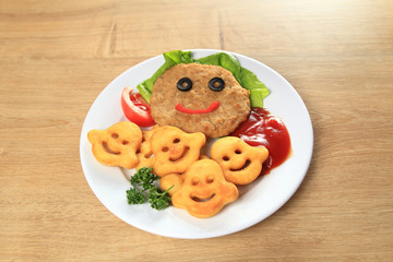 cutlet with garnish on a plate on the table in the children's restaurant 