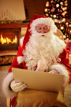Christmas father in his living room with laptop
