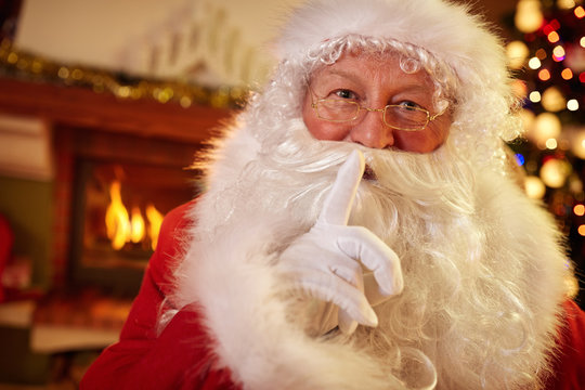 Santa holding a finger to his mouth