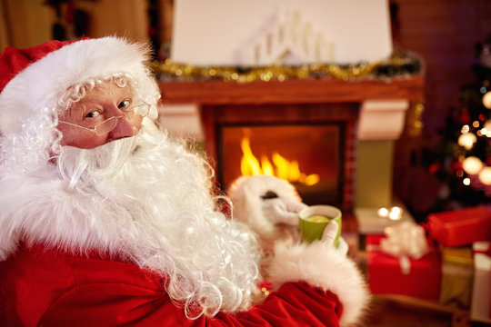 Portrait Santa Claus enjoying drinking tea for Christmas holiday