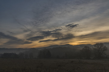 Sunrise under Milesovka hill in winter