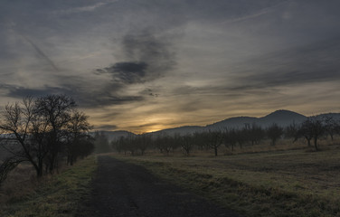 Sunrise under Milesovka hill in winter