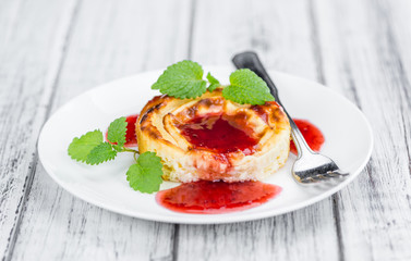 Cheesecake with Sauce on vintage wooden background