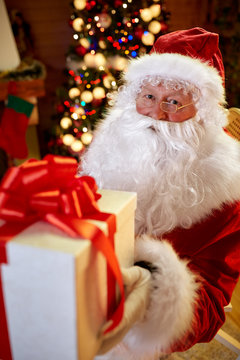 Santa Claus giving gift for you .