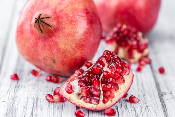 Pomegranate seeds on wooden background (selective focus)