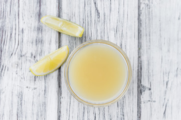 Fresh made Lemon Juice on a rustic background