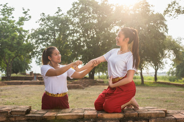 Two Beautiful young girl Thai Dancing art, pantomime performance