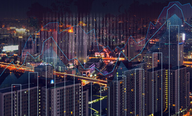 Trading graph on the cityscape at night and world map background