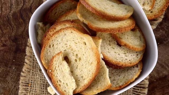 Bread Chips as seamless loopable 4K UHD footage (rotating on a wooden plate)