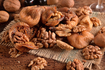 Dried figs with nuts and wine on table