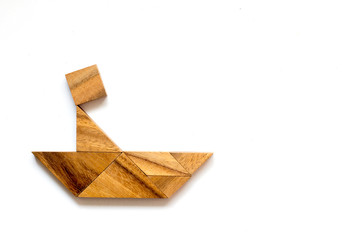 Wooden tangram as man scull boat shape on white background