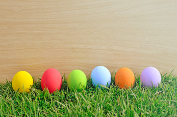 Fototapeta na wymiar Easter eggs in a row on the meadow