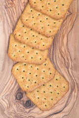 Vegetable crackers on olive wood cutting board