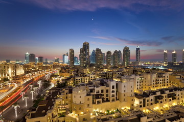 The Palace Hotel in the grounds of the Burj Khalifa park viewed towards the high rises of Dubai Marina area, Dubai