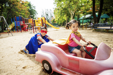 Fototapeta na wymiar Kids Playing Riding Cart Outdoors Fun Nature Concept