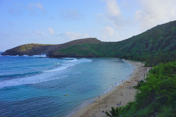 Beautiful scenery of the Hanauma Bay Nature Preserve (formed within a tuff ring and created mainly by volcano eruption) with blue sky and green hill