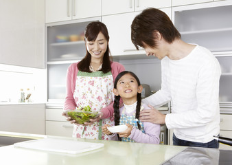 Parents and daughter in kitchen