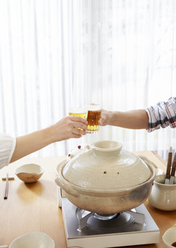 Couple's hands having a toast with beer