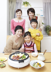 Three-generation family sitting around yosenabe