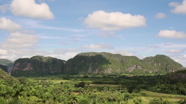 Cuban nature, countryside, landscape and natural beauty. View of country fields, hills and mountains in Vinales (Vi&ntilde;ales), Cuba. Wide angle shot, time lapse