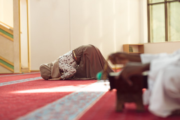 Hand of muslim black man people praying with mosque interior background