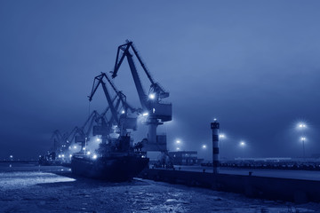 Port gantry crane at work, in the cargo terminal