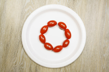 Mini Cherry Tomatoes on a white plate with wood background