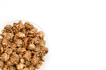 Chocolate popcorn in glass bowl on white background and copy spa