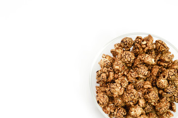 Chocolate popcorn in glass bowl on white background and copy spa