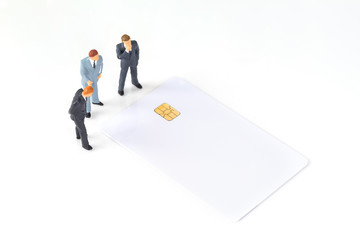 discussing miniature businessmen with chip card