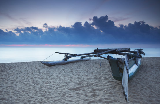 Oruwa (outrigger canoe) on beach at sunset, Negombo, North Western Province, Sri Lanka