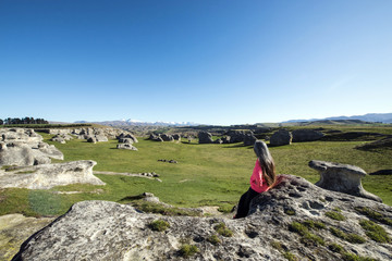 Woman sitting on Elephant rock, South Island New Zealand
