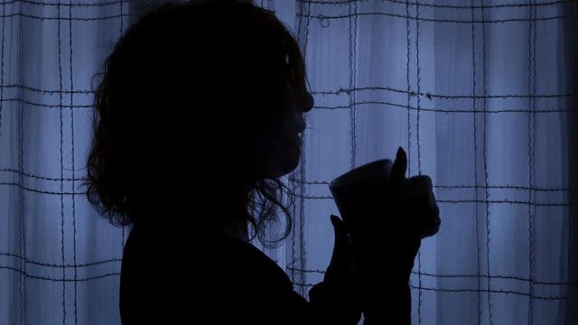 pensive girl closed in her dark room, depressed after a rape