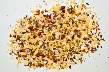 on white background colorful mixture of garlic, spices, paprika, herbs, vegetables