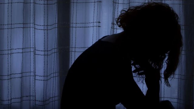 unpset woman sat alone in ther room complaining on her mistakes