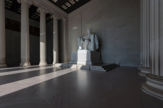 Statue of Abraham Lincoln at sunrise in the Lincoln Memorial Washington DC USA